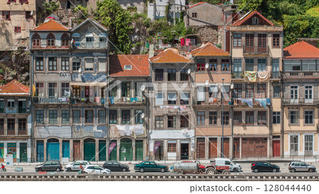 Traditional quaint houses in the old, vintage and touristic ribeira district of Porto at sunny day timelapse, Portugal Traditional quaint houses in the old, vintage and touristic ribeira district of Porto at sunny day timelapse, Portugal 128044440