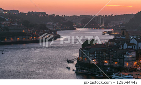 Day to night view of the historic city of Porto, Portugal timelapse from the Dom Luiz bridge 128044442
