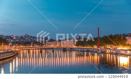 Hyperlapse of the Passerelle du Palais du Justice bridge over the Saone River in Lyon, transition from day to night timelapse. 128044919