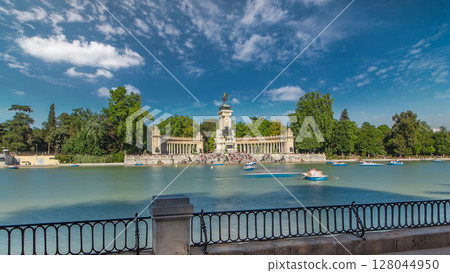 Tourists on boats at Monument to Alfonso XII timelapse hyperlapse in the Park of the Pleasant Retreat in Madrid, Spain 128044950