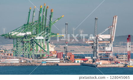 Aerial view of container cargo terminal of commercial port timelapse, business logistics and transport industry in Sines, Portugal. Aerial view of container cargo terminal of commercial port timelapse, business logistics and transport industry in Sines, Portugal. 128045065