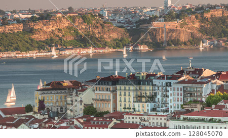 Overview from red roofs of Bairro alto district aerial timelapse of the city of Lisbon to the municipality of Almada. Portugal Overview from red roofs of Bairro alto district aerial timelapse of the city of Lisbon to the municipality of Almada. Portugal 128045070