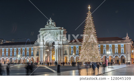 Commerce Square in Lisbon illuminated at Christmas hyperlapse, with a towering tree and crowds celebrating at night. Portugal Commerce Square in Lisbon illuminated at Christmas hyperlapse, with a towering tree and crowds celebrating at night. Portugal 128045109
