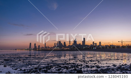 Seaside skyline of Kuwait city from night to day timelapse 128045193