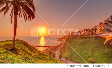 Aerial sunset view of Lima's Coastline in the neighborhood of Miraflores timelapse, Lima, Peru 128045203