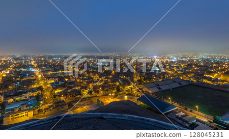 Panoramic skyline of Lima city from above with many buildings aerial night to day transition timelapse. Lima, Peru Panoramic skyline of Lima city from above with many buildings aerial night to day transition timelapse. Lima, Peru 128045231