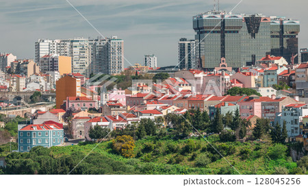 Aerial view of Lisbon skyline with Amoreiras shopping center towers. Historic buildings near Campo de Ourique district with green trees timelapse Aerial view of Lisbon skyline with Amoreiras shopping center towers. Historic buildings near Campo de Ourique district with green trees timelapse 128045256