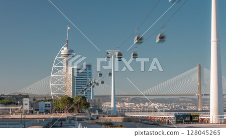 Promenade area of River Tagus in park of nations district timelapse hyperlapse, Vasco da Gamma Bridge. Cable car Lisbon Promenade area of River Tagus in park of nations district timelapse hyperlapse, Vasco da Gamma Bridge. Cable car Lisbon 128045265