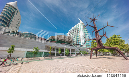 Visitors coming in and out of the Vasco da Gama Shopping mall timelapse hyperlapse, modern towers in the background. Lisbon, Portugal Visitors coming in and out of the Vasco da Gama Shopping mall timelapse hyperlapse, modern towers in the background. Lisbon, Portugal 128045266