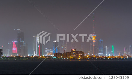 Skyline with Skyscrapers night timelapse in Kuwait City downtown illuminated at dusk. Kuwait City, Middle East Skyline with Skyscrapers night timelapse in Kuwait City downtown illuminated at dusk. Kuwait City, Middle East 128045399