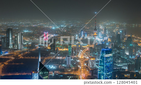 Skyline with Skyscrapers night timelapse in Kuwait City downtown illuminated at dusk. Kuwait City, Middle East Skyline with Skyscrapers night timelapse in Kuwait City downtown illuminated at dusk. Kuwait City, Middle East 128045401