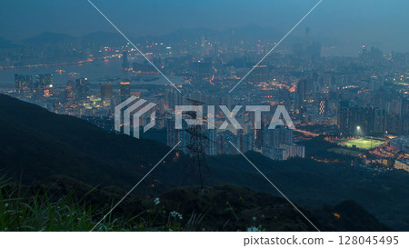 Day to night timelapse from Fei ngo shan Kowloon Peak night Hong Kong cityscape skyline. 128045495