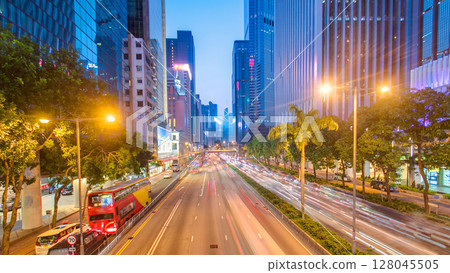 Hong Kong street with busy traffic and skyscraper office at dusk day to night timelapse. Hong Kong street with busy traffic and skyscraper office at dusk day to night timelapse. 128045505