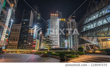 Night view hyperlapse of modern city in park with fountain and skyscrapers around. Time lapse. Hong Kong 128045535