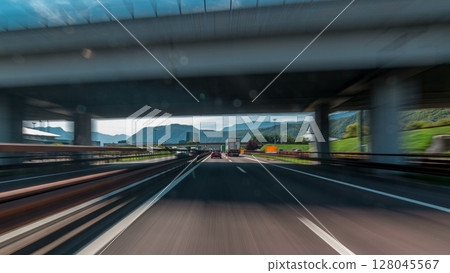 Driving on a highway through the mountains and meadows in Italy timelapse hyperlapse drivelapse 128045567