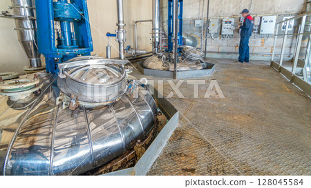 A number of steel tanks for mixing liquids timelapse hyperlapse. Stainless steel, industry. A number of steel tanks for mixing liquids timelapse hyperlapse. Stainless steel, industry. 128045584