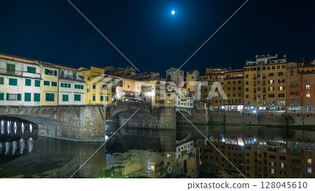 Famous Ponte Vecchio bridge timelapse hyperlapse over the Arno river in Florence, Italy, lit up at night 128045610