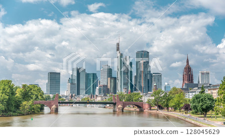 Hyperlapse of Frankfurt's skyscrapers skyline with the bell tower overlooking Alte Brucke. Frankfurt, Germany Hyperlapse of Frankfurt's skyscrapers skyline with the bell tower overlooking Alte Brucke. Frankfurt, Germany 128045629