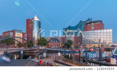 Jan Fedder Promenade day to night timelapse hyperlapse in Hamburg, Germany, a vibrant waterfront area. 128045654