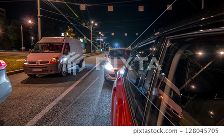 Drivelapse from side of car moving on a night avenue in city timelapse hyperlapse 128045705
