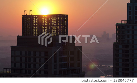 Sunrise in Dubai Marina with towers from skyscrapers rooftop, Dubai, UAE timelapse 128045777