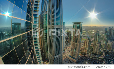Sunrise panorama in Dubai Marina with towers and harbor with yacht from skyscrapers rooftop, Dubai, UAE timelapse Sunrise panorama in Dubai Marina with towers and harbor with yacht from skyscrapers rooftop, Dubai, UAE timelapse 128045780