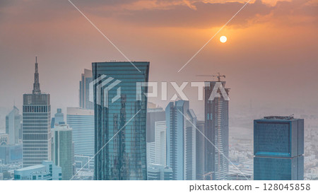 Skyscrapers at sunset timelapse in the skyline of commercial center of Doha, the capital Qatar Skyscrapers at sunset timelapse in the skyline of commercial center of Doha, the capital Qatar 128045858