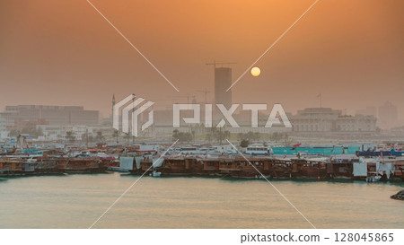 Sunset at Doha Bay timelapse with Traditional Wooden Dhow Fishing Boats. Sunset at Doha Bay timelapse with Traditional Wooden Dhow Fishing Boats. 128045865