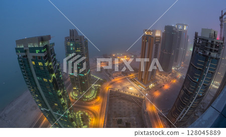 The skyline of the West Bay area from top in Doha day to night timelapse, Qatar. 128045889
