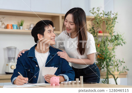 Couple Discussing Financial Goals. Young partners reviewing savings and budgeting together. Couple Discussing Financial Goals. Young partners reviewing savings and budgeting together. 128046515