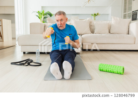 Fitness workout training. Senior man boxing punching picking up dumbbells. Old adult mature healthy man doing sports exercise at home. Grandfather have workout rehabilitation. Health care healthy 128046799