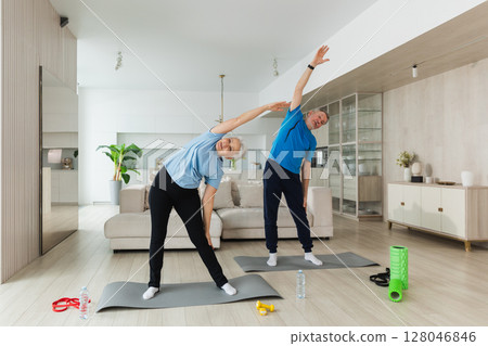 Fitness training. Senior mature healthy fit couple doing sports exercise at home. Mid age husband wife have training workout. Health care healthy lifestyle. Workout rehabilitation for old man woman Fitness training. Senior mature healthy fit couple doing sports exercise at home. Mid age husband wife have training workout. Health care healthy lifestyle. Workout rehabilitation for old man woman 128046846