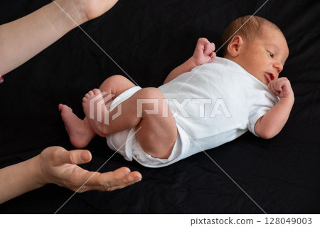 Newborn Baby on Black Background 128049003