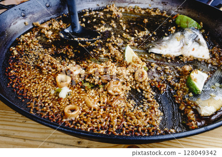 sea bass paella nearly finished 128049342