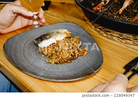 plate with fish and rice, and a beer glass plate with fish and rice, and a beer glass 128049347