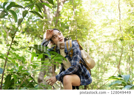 Resting in Nature. Woman taking a break while hiking. 128049449