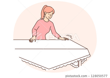Woman housewife sets table with white tablecloth preparing for festive dinner or lunch with family 128050577