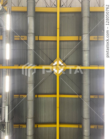 Construction details inside industrial roofs 128050762