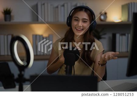 Content Creator Engaging in Live Streaming with Headphones Content Creator Engaging in Live Streaming with Headphones 128051253