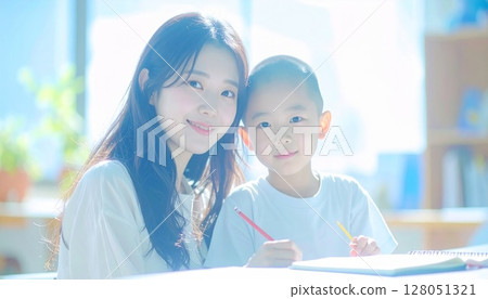 Mother and child studying together at home smile at ease at the camera 128051321