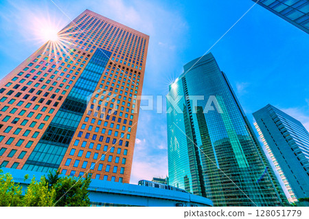 Tokyo cityscape, Japan, July 4th. View of the Shiodome office buildings, including Shiodome City Center and Shiodome Tower. Tokyo cityscape, Japan, July 4th. View of the Shiodome office buildings, including Shiodome City Center and Shiodome Tower. 128051779
