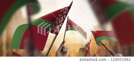 Belarus flags in their hands on a blurred urban background 128051962