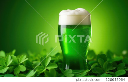 Glass of green foamy irish beer stands on green grassy clover background. St. Patrick Day 128052064