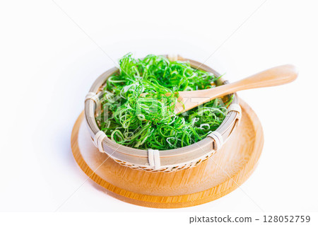 Finely chopped green onions in a colander Finely chopped green onions in a colander 128052759