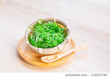 Finely chopped green onions in a colander Finely chopped green onions in a colander 128052760