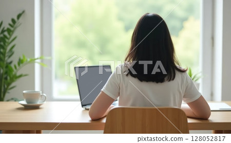 Person working at minimalist home office desk, back view 128052817