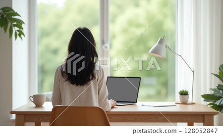 Person working at minimalist home office desk, back view 128052847