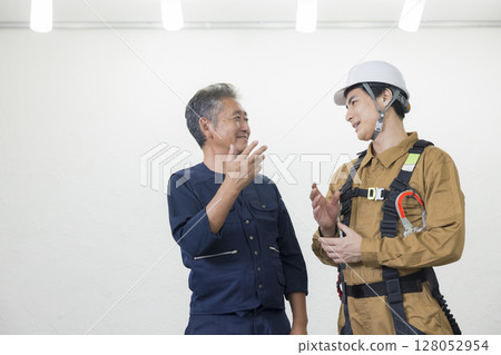 Male worker wearing a full harness Male worker wearing a full harness 128052954