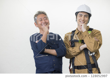 Male worker wearing a full harness Male worker wearing a full harness 128052997