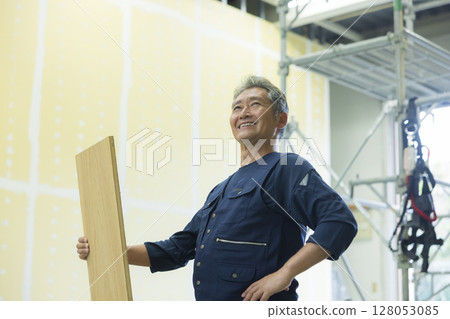 Carpenter holding wood Carpenter holding wood 128053085